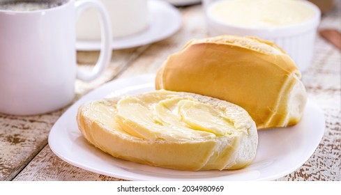 slice of salt bread cut with butter, called French bread in Brazil, Brazilian breakfast