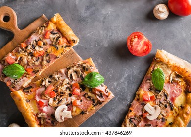 A Slice Of Square Pizza With Basil Tomatoes And Mushrooms On A Wooden Board. 