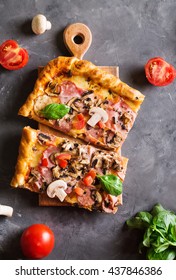 A Slice Of Square Pizza With Basil Tomatoes And Mushrooms On A Wooden Board. 