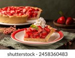 A slice of Strawberry jello pie with heavy cream. Baked homemade crust pie with no-bake filling. Lots of fresh strawberry and strawberry gelatin made with gelatin and cornstarch.