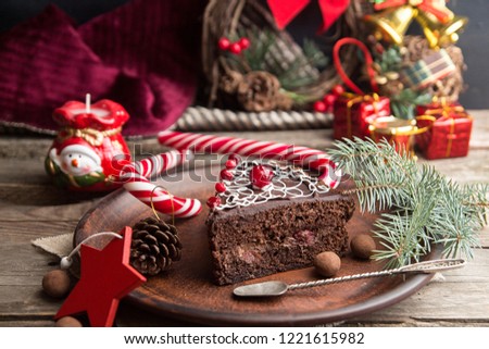 Slice of sweet chocolate cake for Christmas Eve. Christmas decoration.