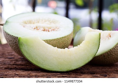Slice of sweet green melon on wooden table. - Shutterstock ID 1149877334