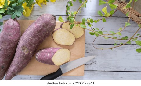 Slice the sweet potato on a cutting board. - Powered by Shutterstock