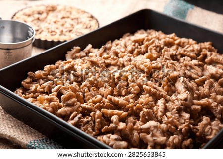 A slice of walnut pie, a rustic dessert with a nutty flavor.