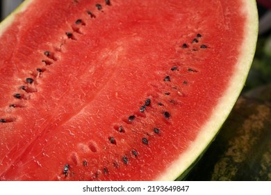  Slice Of Watermelon Close Up. A Watermelon Cut In Half On A Background Of Whole Watermelons           