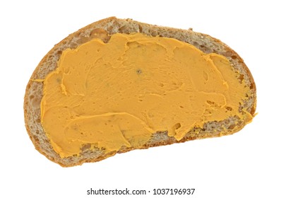 A Slice Of Wheat Bread With Cheddar Cheese Spread Isolated On A White Background