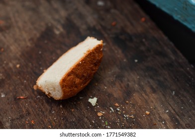 Slice of white bread on a dark dirty wooden board