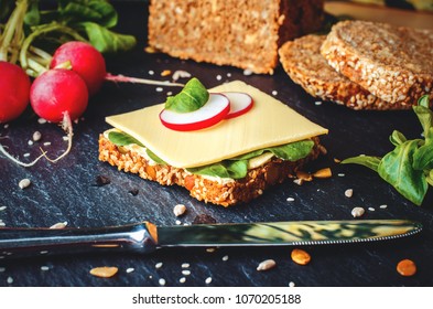 Slice Of Whole Grain Bread With Cheese, Salat And Radish On Slate