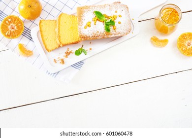 Slice And Whole Orange Bread On Board, Jam And Fresh Mandarin Over White Wooden Table. Top View With Place For Text.