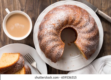 Slice Of Yogurt Bundt Cake Served With A Cup Of Coffee With Milk. Top View