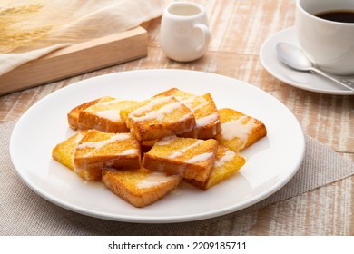 Sliced Air Fryer Grilled Butter Toast,golden Brown Crispy Bread Topped With Sugar And Sweetened Condensed Milk On White Plate