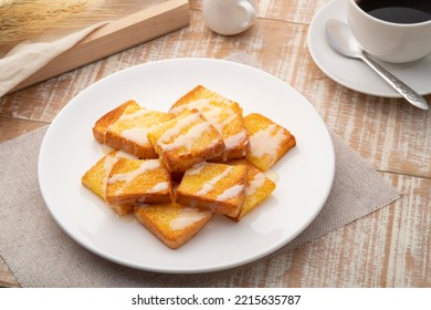 Sliced Air Fryer Grilled Butter Toast,golden Brown Crispy Bread Topped With Sugar And Sweetened Condensed Milk On White Plate