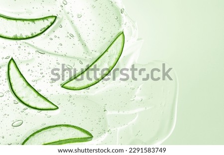 sliced aloe slices in green color aloe gel, flat lay, body and skin care concept