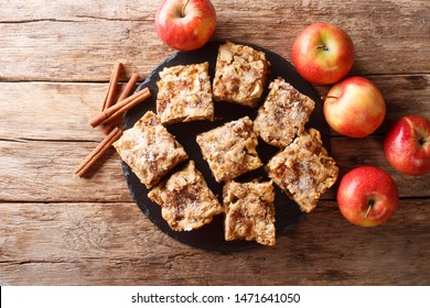 Sliced Apple Blondies With Cinnamon And Nuts Close-up On A Slate Board On The Table. Horizontal Top View From Above
