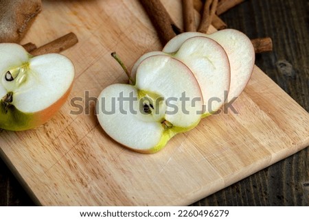 Sliced apple on a chopping board, ripe crispy and juicy apple cut into pieces on a chopping board