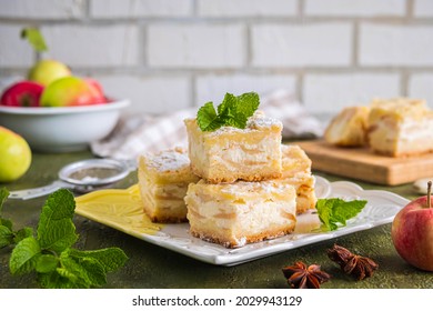 Sliced Apple Pie Made From Shortcrust Pastry With Cottage Cheese Cream And Apple Wedges On A Square Plate On A Green Concrete Background. Apple Pie Recipes. Thanksgiving Day.