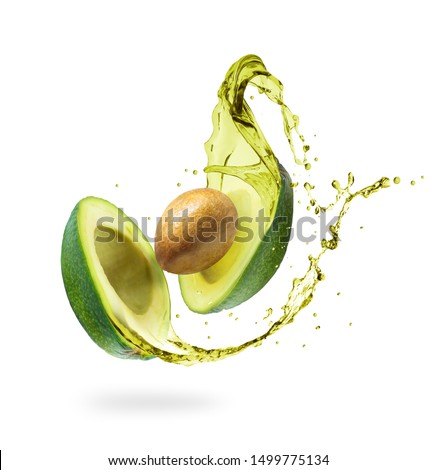 Sliced avocado with splashes isolated on white background