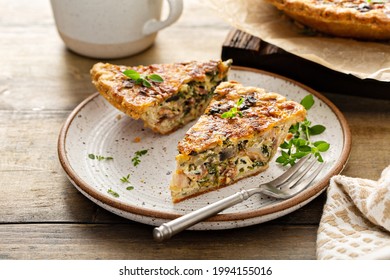 Sliced Of Bacon, Mushroom And Spinach Quiche With Cheddar Cheese And Herbs, Rustic Breakfast Dish