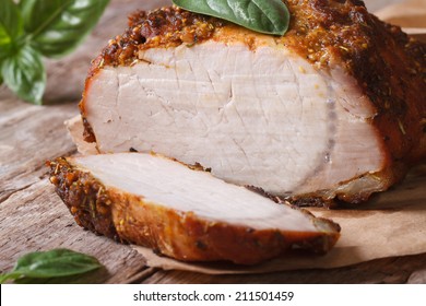 Sliced baked pork fillet and basil close-up on the paper on the table. horizontal  - Powered by Shutterstock