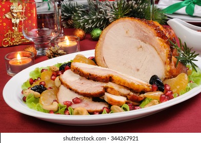 Sliced Baked Turkey Ham With Fruit Garnish On The Christmas Table