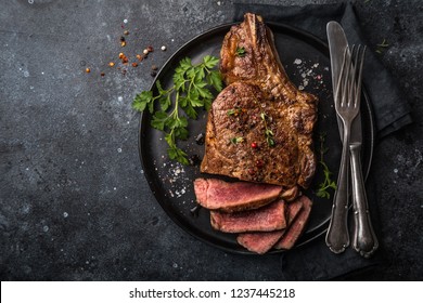 Sliced Beef Steak On Black Plate, Dark Background, Top View, Copy Space