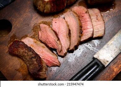 Sliced beef tenderloin on a chopping board