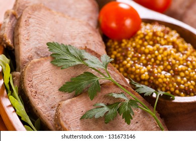 Sliced beef tongue with mustard