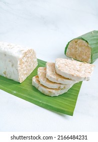 Sliced ​​tempeh With A Bigger And Out Of Focus Piece Behind It. Tempeh Or Tempe Is A Traditional Indonesian Food Made From Fermented Soybeans.