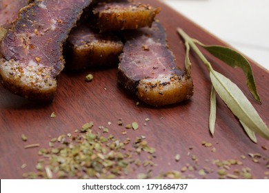 
sliced biltong on chopping board with spice