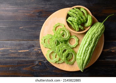 Sliced bitter melon or bitter gourd on wooden board prepare for cooking, Table top view