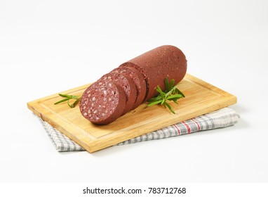 sliced blood sausage on cutting board