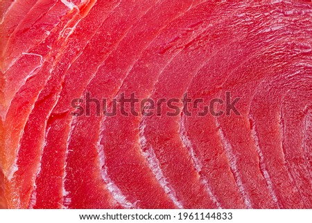 sliced bluefin tuna raw meat texture, close-up.