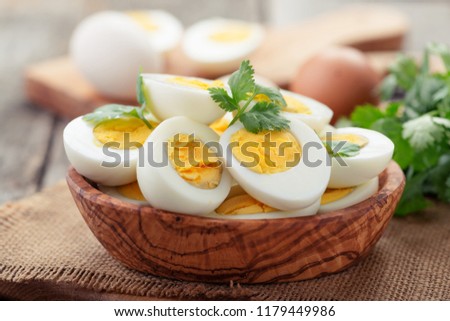 Sliced boiled eggs,decorated with parsley leaves.