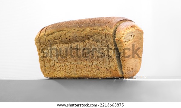 Sliced  bread in cutting\
machine,  Industrial bread Slicer in supermarket with bread crumbs,\
ready to use.