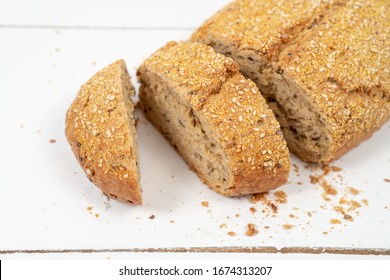 Sliced Bread With Sesame Seeds On The White Wooden Boards - Shutterstock ID 1674313207