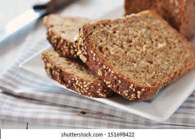 Sliced bread with sunflower seeds and sesame on a plate