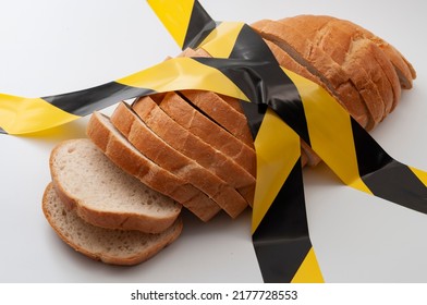 Sliced Bread And Yellow Caution Tape Isolated On White Background Concept For Food Insecurity, Hunger Warning And Hazardous Processed Grain