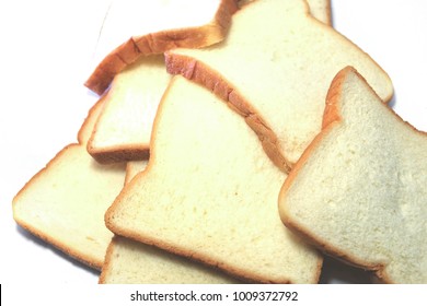 Sliced Bread.Multiple Sheets Bread.pile Bread On A White Background. It Is Made From Wheat Flour Mixed With Water And Yeast Or Baking Powder. Can Be Used As A Background Image For Food And Cakes.