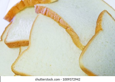 Sliced Bread.Multiple Sheets Bread.pile Bread On A White Background. It Is Made From Wheat Flour Mixed With Water And Yeast Or Baking Powder. Can Be Used As A Background Image For Food And Cakes.