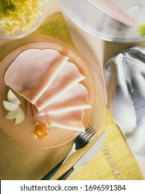 
Sliced ​​turkey Breast Overhead View On Orange Round Plate With Cutlery