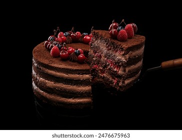 Sliced ​​chocolate cake with fruit filling decorated with raspberries, cherries and blueberries on a black background - Powered by Shutterstock