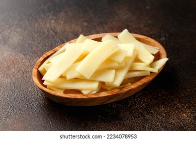 Sliced canned bamboo shoots in wooden bowl. - Shutterstock ID 2234078953