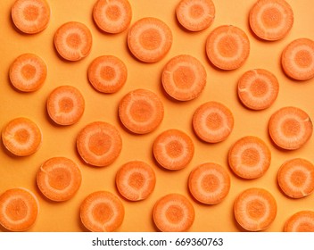 Sliced Carrot On Orange Color Background