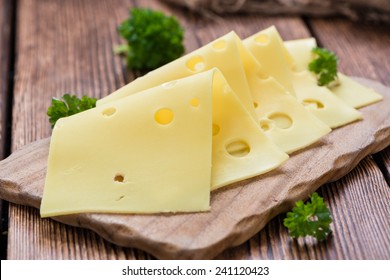 Sliced Cheese (close-up Shot) On Vintage Wooden Background