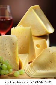 Sliced cheese, grapes and a glass of red wine