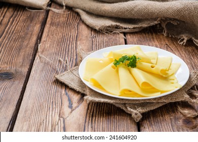 Sliced Cheese On Rustic Wooden Background (close-up Shot)