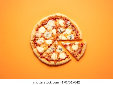 Sliced Cheese Pizza On An Orange Background Above View. Pizza Sliced In Eight. Delicious Homemade Pizza Top View. Pizza Made Only With Cheese And Tomato Sauce.