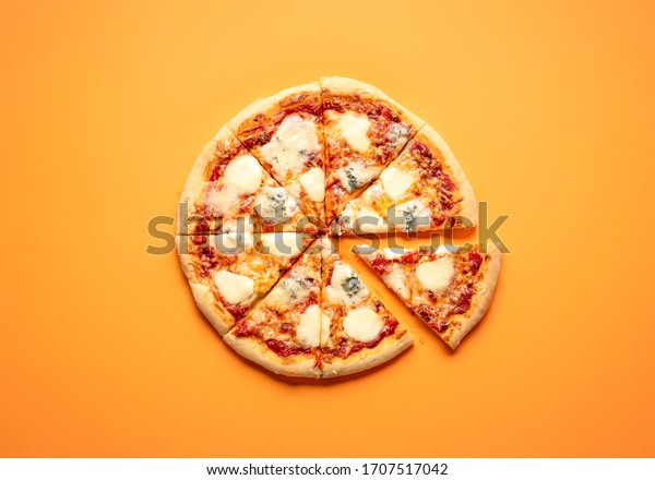 Sliced cheese pizza on an orange\
background above view. Pizza sliced in eight. Delicious homemade\
pizza top view. Pizza made only with cheese and tomato\
sauce.