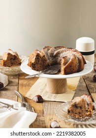 Sliced Chestnut Vegan Bundt Cake Served On A Rustic Wooden Brown Table Dusted With Sugar