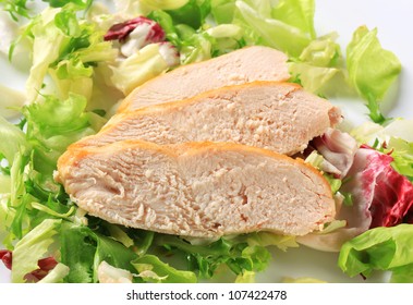 Sliced Chicken Breast Fillet On A Nest Of Green Salad